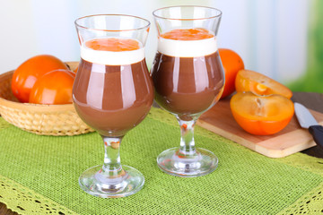 Dessert of chocolate and persimmon on table on light background