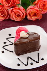 Sweet cake with chocolate on plate on table close-up