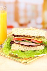 Fresh and tasty sandwich on plate on table on light background