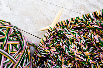 Knitting needles and yarn on wooden background