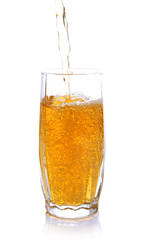 Juice pouring into glass isolated on white