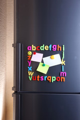 Colorful magnetic letters on  refrigerator