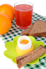 Boiled egg in egg cup on table close-up