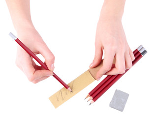 Hands with pencils and erase isolated on white