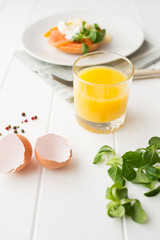 Breakfast with fresh orange juice, salad and poached eggs