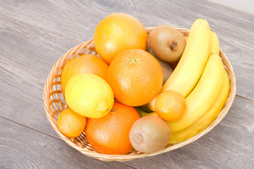bananas, lemons and oranges in a straw basket