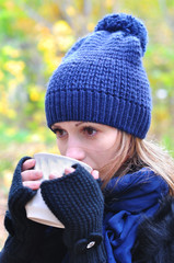 Girl drinking tea in the cold