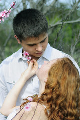 Obraz premium beautiful young couple in love among the flowering trees