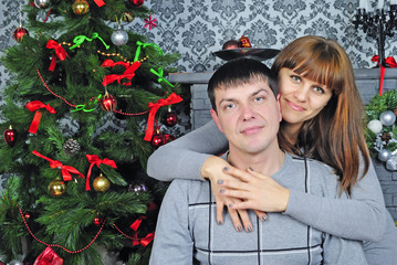 young couple in love near new year's fir tree