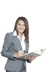 Business woman asian attractive standing using a pen writing dia