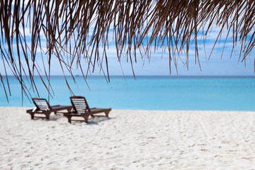 Relaxing chairs in front of the Indian Ocean in Maldive Islands