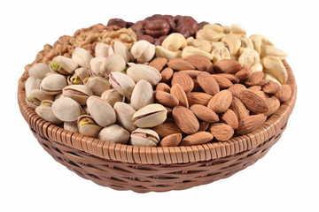 Assorted nuts in a wicker bowl on a white background