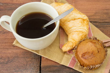 Croissant with banana cupcake and black coffee
