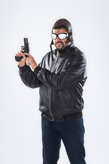 Arrogant young man holding a gun pointed upwards