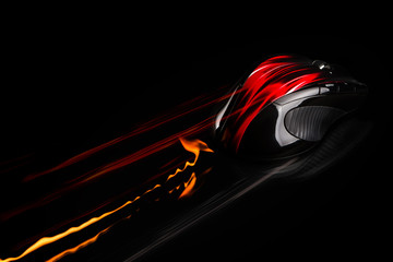 PC mouse in fast motion with flames and light trails.