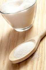 Spoon next to a bowl of sugar