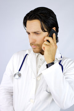 Serious young doctor on the phone