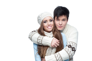 young smiling couple in winter clothing embracing