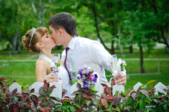 bride and groom in the park, a wedding bouquet, wedding dresses
