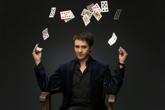 Young man juggling cards