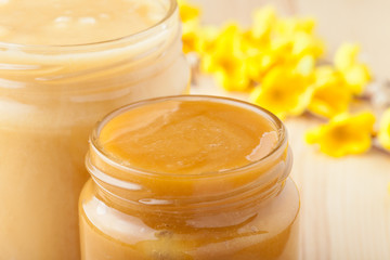jars of honey and yellow blossom twig