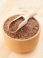 linseed, flax seeds with wooden scoop in mortar