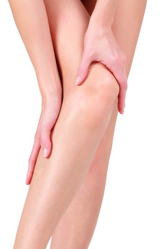 Woman holding sore knee, isolated on white background