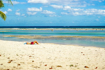 Fototapeta na wymiar Sunbathing on a Caribbean beach by the sea