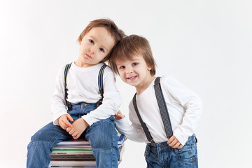 Two boys on a pile of books