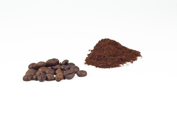 Roasted coffee beans and ground coffee on white background