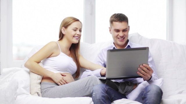 happy family looking with laptop computer