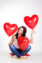 Fototapeta na wymiar valentine's day beautiful young woman with red balloons