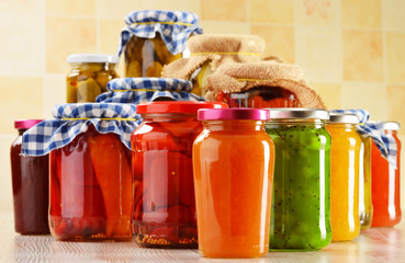 Jars of marinated food. Pickled vegetables and jams