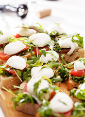 Tomato, mozzarella and arugula sandwich