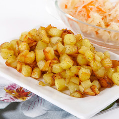 Fried potato cubes  with sour cabbage