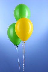 Three colorful balloons on blue background