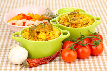 Delicious pilaf with vegetables on tablecloth background