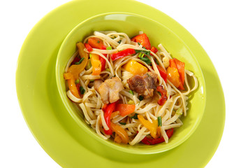 Noodles with vegetables on plate isolated on white