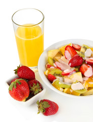 Useful fruit salad of fresh fruits and berries in bowl isolated