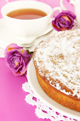 Delicious poppy seed cake with cup of tea on table close-up