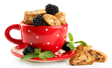 Tasty cookies with blackberry in cup isolated on white