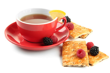 Cup of tea with cookies and berries isolated on white