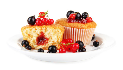 Tasty muffins with berries isolated on white