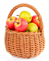 Small apples in wicker basket, isolated on white