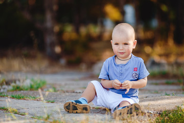 Little toddler boy walking in summer park outdoor