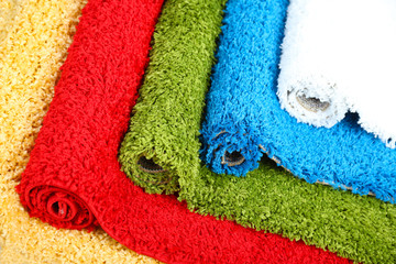 Many carpets of different colors close-up