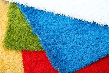 Many carpets of different colors close-up