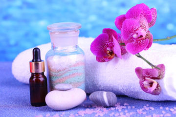 Beautiful spa setting with orchid on blue background