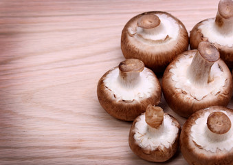 Mushrooms over wooden background. Baby Bella