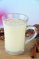 Cup of eggnog with cinnamon and cookies